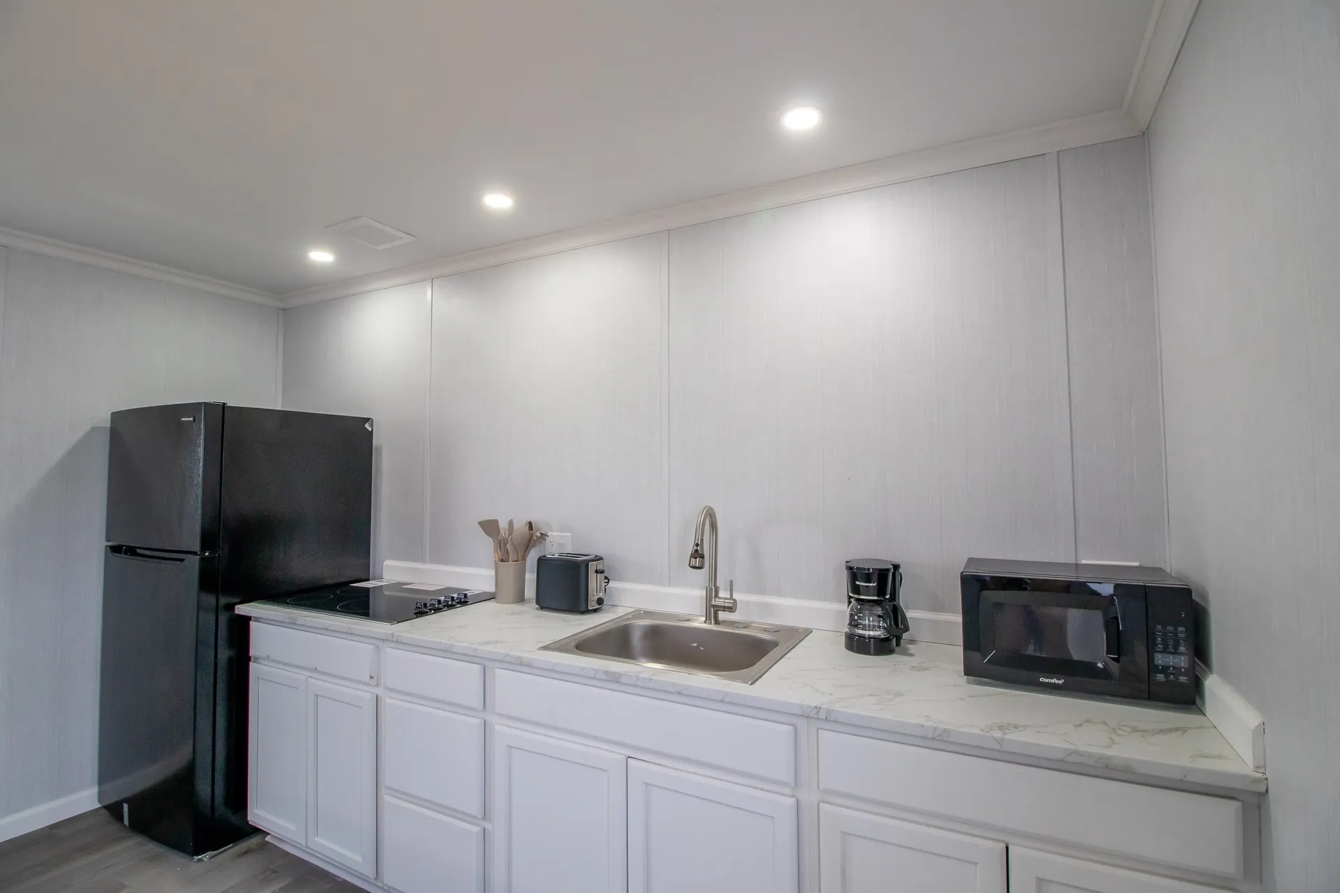 A furnished kitchen with full-sized refrigerator at Sunset Ridge
